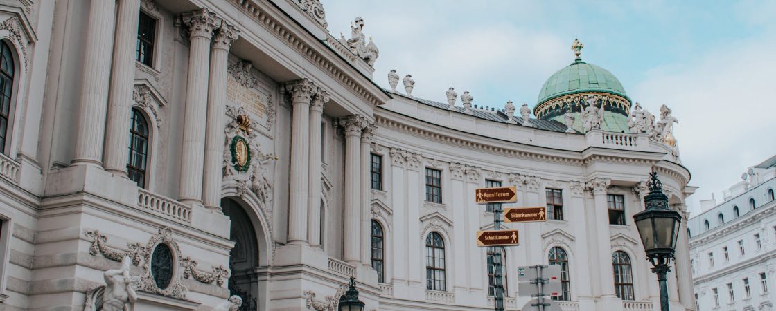 a low angle shot of a famous landmark with sculptures in the building