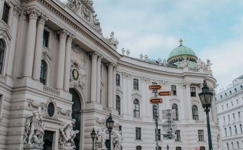 a low angle shot of a famous landmark with sculptures in the building