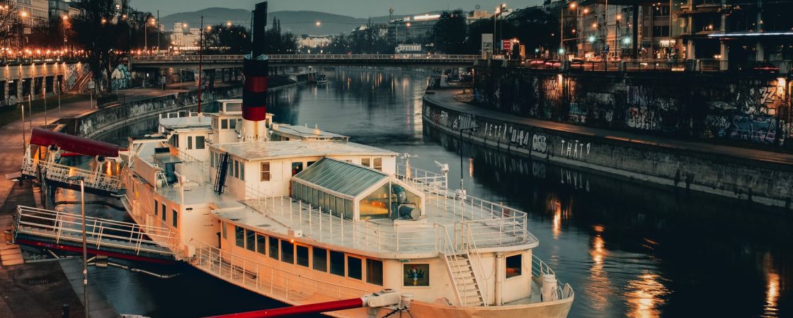 white ship docked with red steel bar
