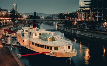 white ship docked with red steel bar