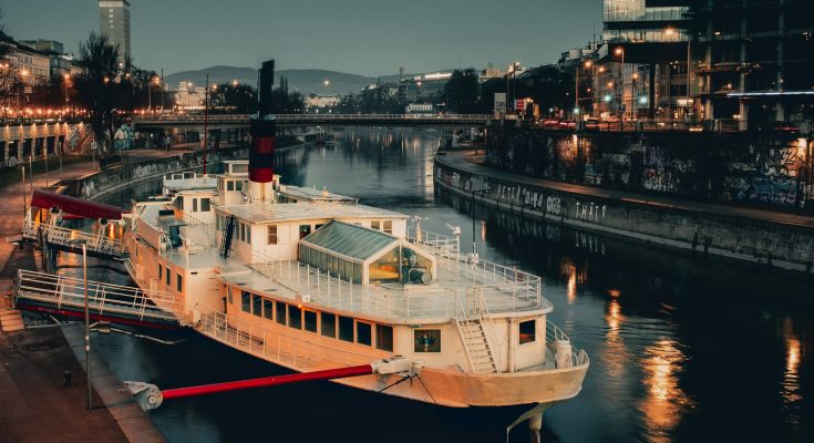 white ship docked with red steel bar