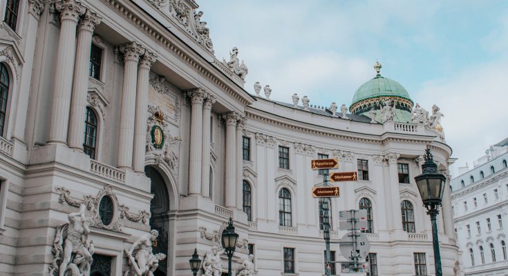 a low angle shot of a famous landmark with sculptures in the building